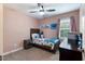 bedroom with a ceiling fan, carpet, bed, and Stitch decor at 486 S Denise Ave, Coats, NC 27521