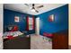 Blue bedroom with a ceiling fan, carpet, and Spiderman decor at 486 S Denise Ave, Coats, NC 27521