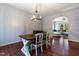 Charming dining room with a farmhouse table, chandelier, and an archway leading into the inviting living area at 486 S Denise Ave, Coats, NC 27521