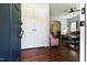 Inviting foyer featuring wood floors and a glimpse into the comfortable living room with an archway at 486 S Denise Ave, Coats, NC 27521
