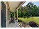 Covered front porch with rocking chairs and accent lighting surrounded by lush landscaping and rock border at 486 S Denise Ave, Coats, NC 27521