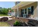Inviting front porch featuring rocking chairs, tasteful landscaping, and a brick base, perfect for relaxing at 486 S Denise Ave, Coats, NC 27521