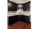 Well-equipped kitchen featuring dark cabinets, granite countertops, and stainless steel sink at 486 S Denise Ave, Coats, NC 27521