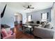 Bright living room with hardwood floors, large sectional sofa, a ceiling fan and a view to the dining area at 486 S Denise Ave, Coats, NC 27521