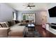 Spacious living room with hardwood floors, large windows, comfortable seating, and a view to the front door at 486 S Denise Ave, Coats, NC 27521