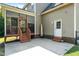 Back porch with stairs, seating and door leading to the backyard at 486 S Denise Ave, Coats, NC 27521