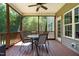 Enclosed porch with a ceiling fan and a dining table with four chairs at 486 S Denise Ave, Coats, NC 27521
