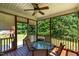 Wooden screened in porch featuring a glass table and 4 chairs at 486 S Denise Ave, Coats, NC 27521