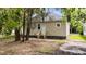 Back of a single story home featuring tan siding and a rear entrance framed by lush, mature trees at 508 Buena Vista Ave, Rocky Mount, NC 27801