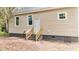 A view of the back of the home featuring tan siding, windows and steps to the back entrance at 508 Buena Vista Ave, Rocky Mount, NC 27801