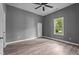 This bedroom features wood-look floors, a closet and a bright window at 508 Buena Vista Ave, Rocky Mount, NC 27801