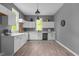 Modern kitchen featuring white cabinets, updated appliances, and hardwood floors at 508 Buena Vista Ave, Rocky Mount, NC 27801