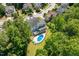 Aerial view of the home nestled among mature trees, highlighting the pool and backyard at 513 Lake Gaston Dr, Fuquay Varina, NC 27526