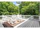 Cozy outdoor deck area with comfortable seating and serene wooded views at 513 Lake Gaston Dr, Fuquay Varina, NC 27526