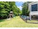 Spacious backyard featuring a playset, pool and wooded backdrop at 513 Lake Gaston Dr, Fuquay Varina, NC 27526
