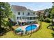Backyard view of a home with a swimming pool, deck and screened porch at 513 Lake Gaston Dr, Fuquay Varina, NC 27526