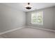 Bedroom features neutral carpet, neutral walls, a ceiling light, and a sunny window at 513 Lake Gaston Dr, Fuquay Varina, NC 27526