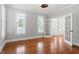 Bright bedroom with gleaming hardwood floors, neutral walls, and french doors leading to another room at 513 Lake Gaston Dr, Fuquay Varina, NC 27526