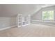 Attic bonus room with custom storage shelving and window seat at 513 Lake Gaston Dr, Fuquay Varina, NC 27526
