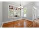 Well-lit dining room with hardwood floors and large windows providing ample natural light at 513 Lake Gaston Dr, Fuquay Varina, NC 27526
