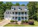 Beautiful two-story home with lush landscaping and a welcoming front porch at 513 Lake Gaston Dr, Fuquay Varina, NC 27526