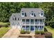 Charming white two-story home with a double porch and a well-manicured front yard at 513 Lake Gaston Dr, Fuquay Varina, NC 27526