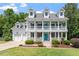 Stunning white two-story home with inviting front porch and beautifully landscaped yard at 513 Lake Gaston Dr, Fuquay Varina, NC 27526