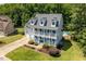 Charming white two-story home with double porches, garage, and manicured lawn at 513 Lake Gaston Dr, Fuquay Varina, NC 27526
