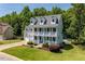 Charming white two-story home with double porches and a well-manicured lawn at 513 Lake Gaston Dr, Fuquay Varina, NC 27526