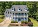Charming white two-story home with a double porch and a well-manicured front yard at 513 Lake Gaston Dr, Fuquay Varina, NC 27526