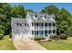 Charming white two-story home with a double porch and a well-manicured front yard at 513 Lake Gaston Dr, Fuquay Varina, NC 27526