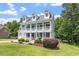Charming two-story white home featuring a spacious front porch and well-manicured lawn at 513 Lake Gaston Dr, Fuquay Varina, NC 27526