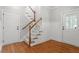 Inviting foyer featuring hardwood floors, staircase, and convenient access to multiple entryways at 513 Lake Gaston Dr, Fuquay Varina, NC 27526