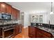 Spacious kitchen with wooden cabinets, granite countertops, and stainless steel appliances at 513 Lake Gaston Dr, Fuquay Varina, NC 27526