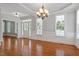 Elegant living room featuring hardwood floors, large windows, and wainscoting at 513 Lake Gaston Dr, Fuquay Varina, NC 27526