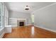 Bright living room showcasing hardwood floors, built-in shelving, and a cozy fireplace at 513 Lake Gaston Dr, Fuquay Varina, NC 27526