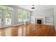 Bright living room with hardwood floors, fireplace, built-in shelves, and access to outdoor space at 513 Lake Gaston Dr, Fuquay Varina, NC 27526