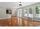 Large living room featuring hardwood floors, lots of natural light, and a partial view to the kitchen at 513 Lake Gaston Dr, Fuquay Varina, NC 27526