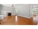 Spacious living room featuring hardwood floors, a fireplace, and built-in shelving at 513 Lake Gaston Dr, Fuquay Varina, NC 27526
