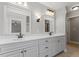 Main bathroom features double sinks, white cabinets and countertops, and a neutral paint scheme at 513 Lake Gaston Dr, Fuquay Varina, NC 27526