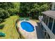 Backyard view showcasing a sparkling pool surrounded by lush greenery and ample space for relaxation at 513 Lake Gaston Dr, Fuquay Varina, NC 27526