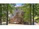 Exterior view of the home showcases the elevated deck and backyard with natural landscaping at 516 Culmore Dr, Fuquay Varina, NC 27526