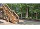 Wooden staircase in wooded backyard of home, leading up to a screened porch at 516 Culmore Dr, Fuquay Varina, NC 27526