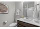 A modern bathroom has a light wood vanity, white sink and commode, a wall mirror and a towel rack at 516 Culmore Dr, Fuquay Varina, NC 27526