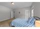 Bedroom with neutral walls, carpet, light and a bed with blue and white checkered covers at 516 Culmore Dr, Fuquay Varina, NC 27526