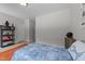 Cozy bedroom featuring neutral walls, a comfy bed, and decor on shelving unit at 516 Culmore Dr, Fuquay Varina, NC 27526