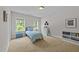 Bright bedroom featuring two windows, light walls, a small dresser, and vinyl record decorations at 516 Culmore Dr, Fuquay Varina, NC 27526