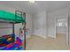 Well-lit bedroom with a loft bed, and a bookshelf with toys and books at 516 Culmore Dr, Fuquay Varina, NC 27526