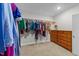 Walk-in closet with hanging racks, dresser, carpet flooring and a light at 516 Culmore Dr, Fuquay Varina, NC 27526