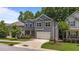 Two-story home with gray siding and a two-car garage complements the green lawn at 516 Culmore Dr, Fuquay Varina, NC 27526